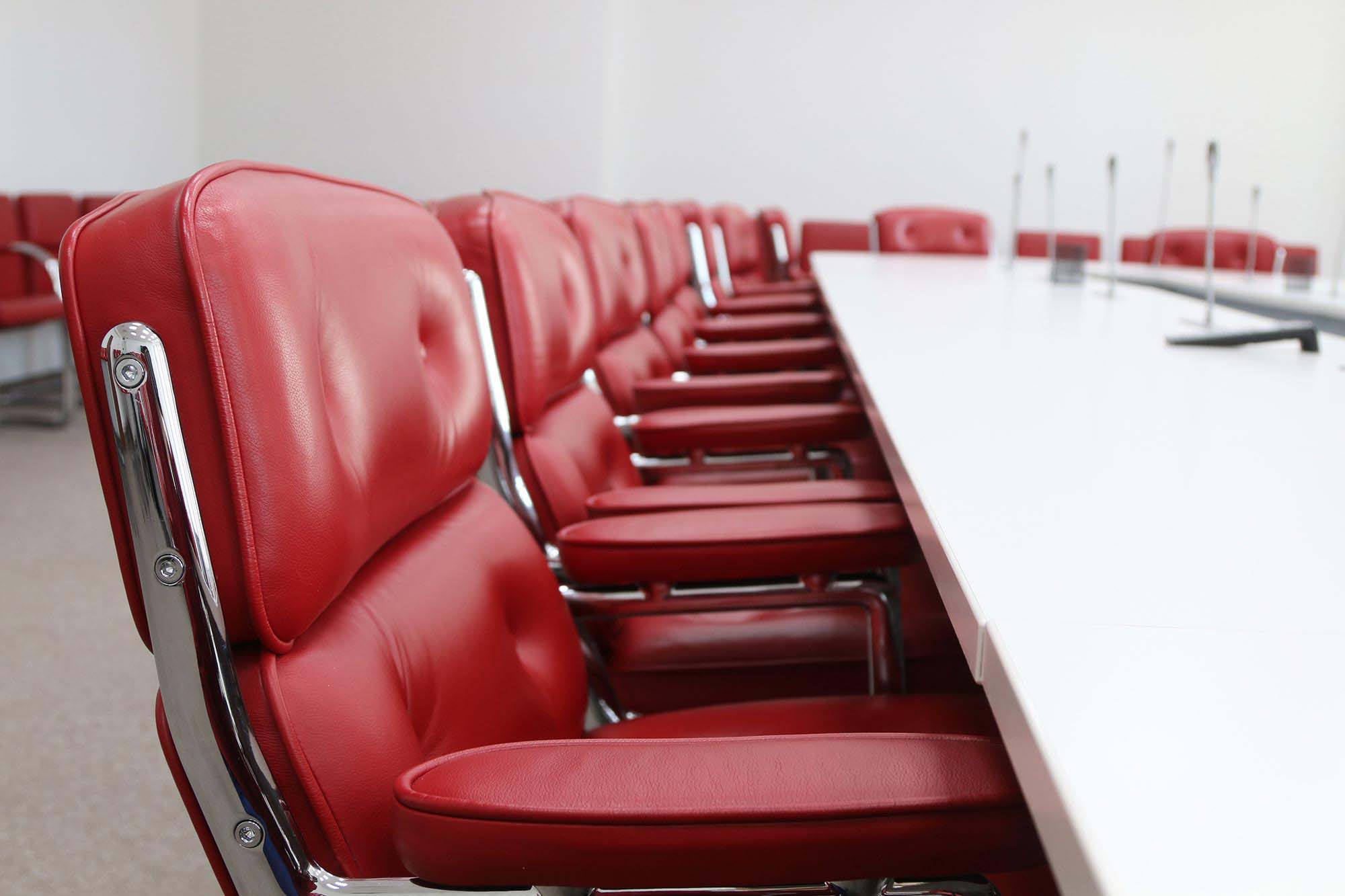 Meetings & Conferences – Luxury meeting room set up with red leather chairs